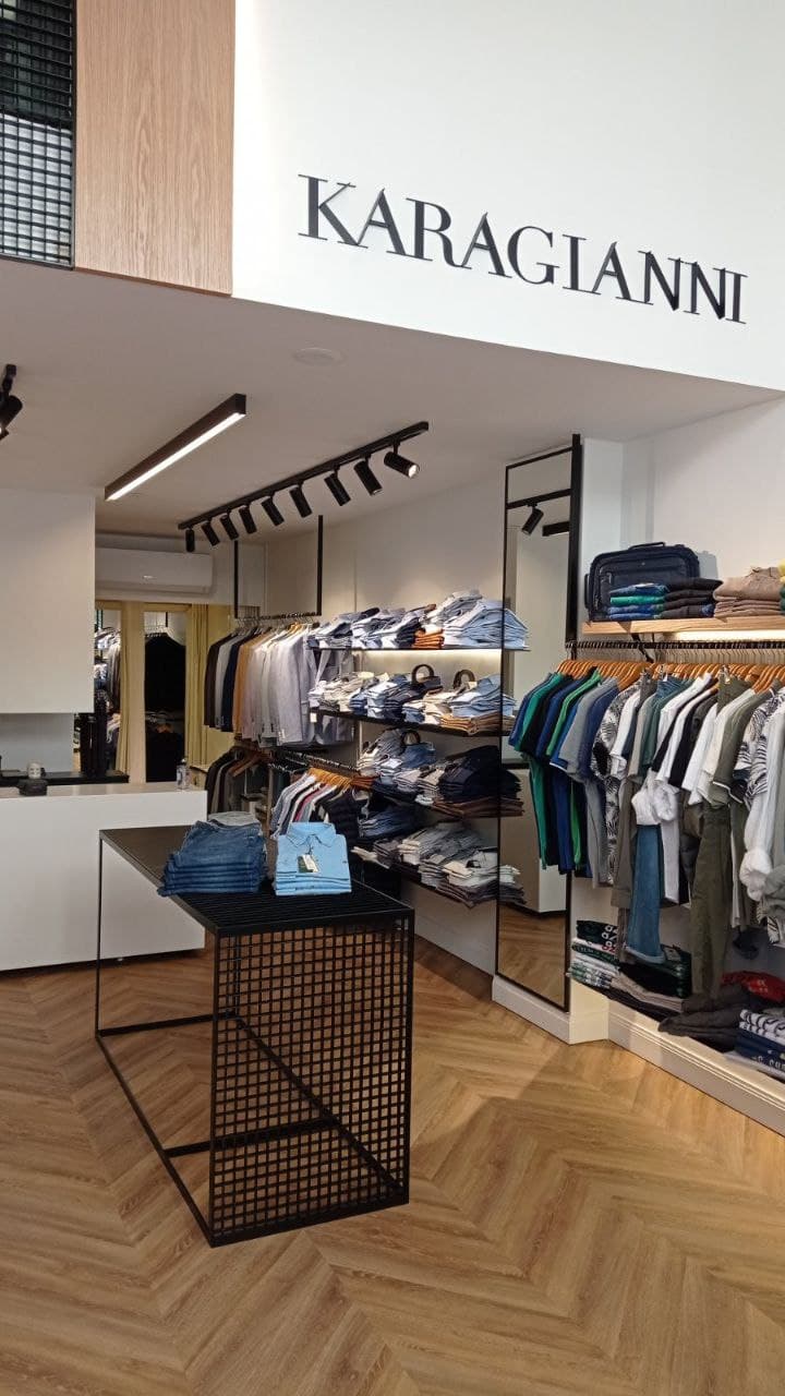 Stack of carefully folded men's wool sweaters and shirts